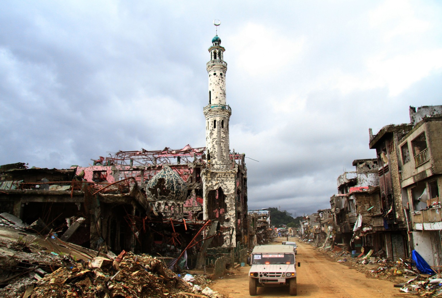 epaselect epa06288122 A military vehicle maneuvers next to a devastated mosque in the ruined city of Marawi, Lanao del Sur province, Philippines, 25 October 2017. President Rodrigo Duterte warned memb ...