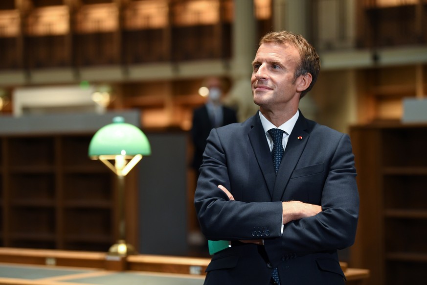 epa09493745 French President Emmanuel Macron looks on as he visits the Richelieu site of the Bibliotheque Nationale de France, after the completion of the renovation project and the 300th anniversary  ...