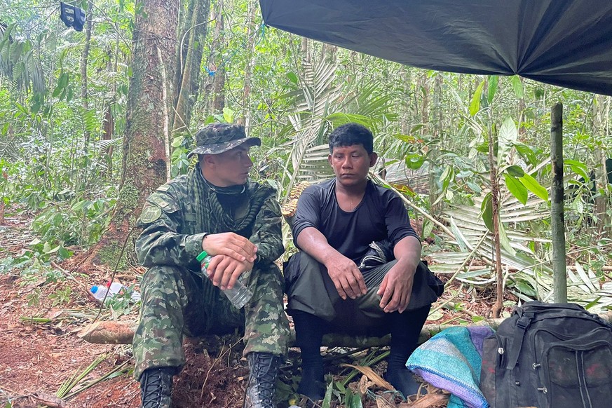 epa10651760 A handout photo made available by the Colombian Military Forces shows Manuel Ranoque (R), father of the four children who disappeared in the jungle after a Cessna 206 plane crash, talking  ...