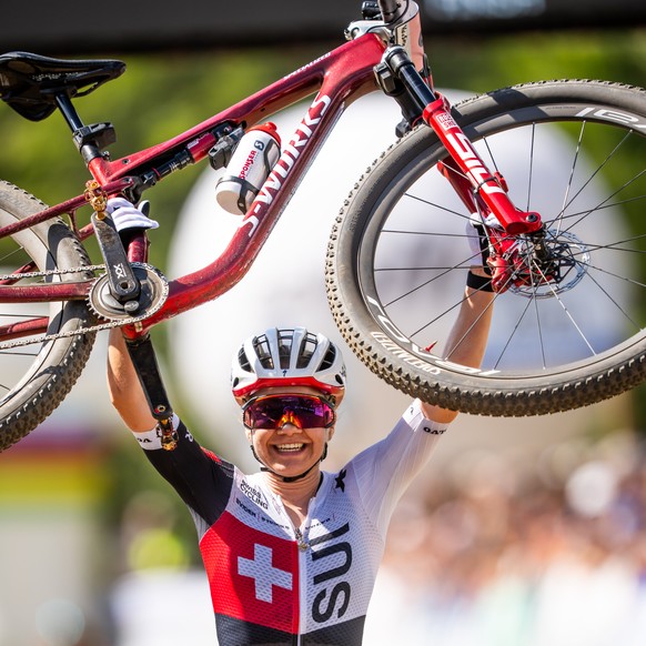 Sina Frei of Switzerland, 1st, crosses the finish line of the Women Elite Cross Country, XCO, Mountain Bike World Championship, on Sunday August 30, 2026, in Val di Sole, Italy.(KEYSTONE/Maxime Schmid ...