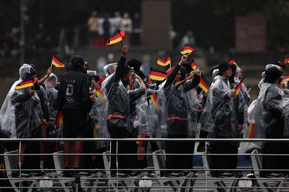 epa11497650 Athletes of Germany react on a boat as they pass by during the Opening Ceremony of the Paris 2024 Olympic Games, in Paris, France, 26 July 2024. EPA/ANNA SZILAGYI
