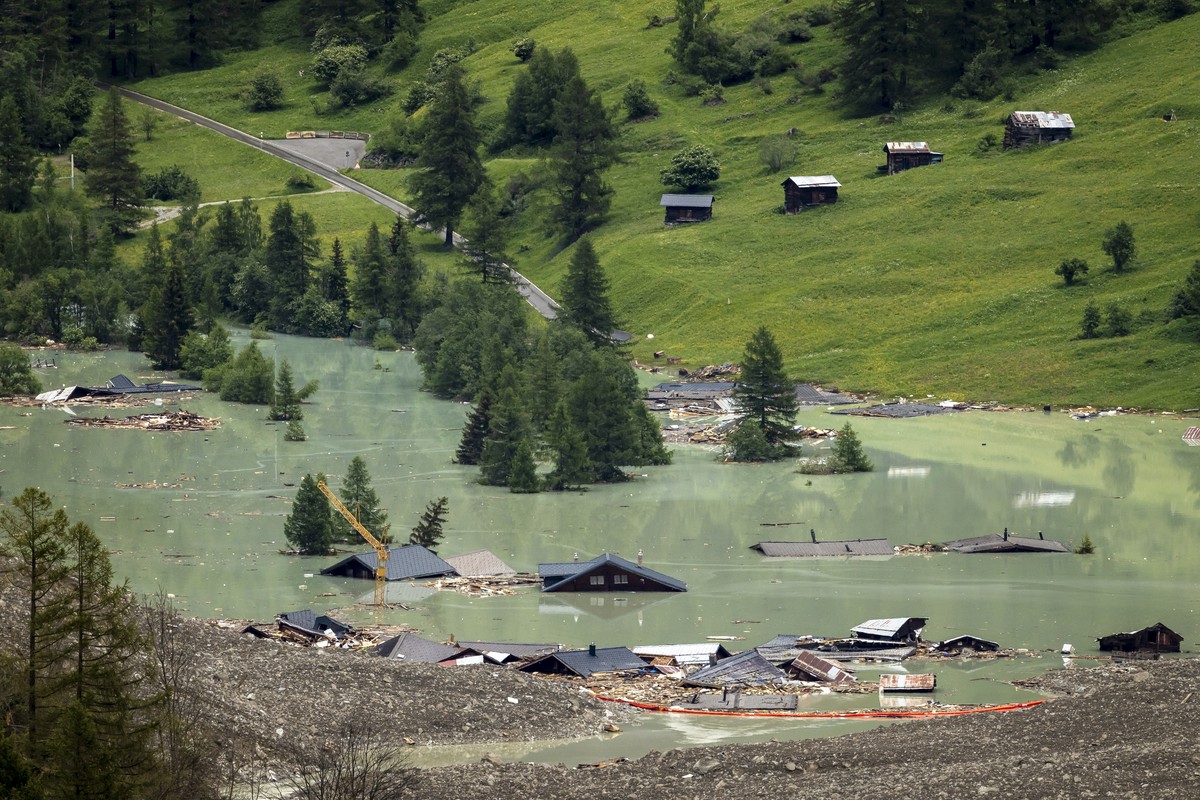 epa12157882 Destroyed houses are submerged in the water from the river Lonza after the formation of a lake on the last houses of the village of Blatten, after a massive avalanche, triggered by the col ...