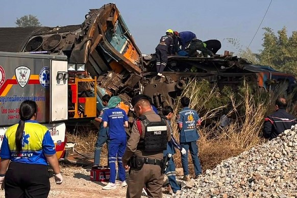 This photo released from State Railway of Thailand, shows aid workers after a construction crane fell into a passenger train in Nakhon Ratchasima province, Thailand Wednesday, Jan. 14, 2026. (State Ra ...