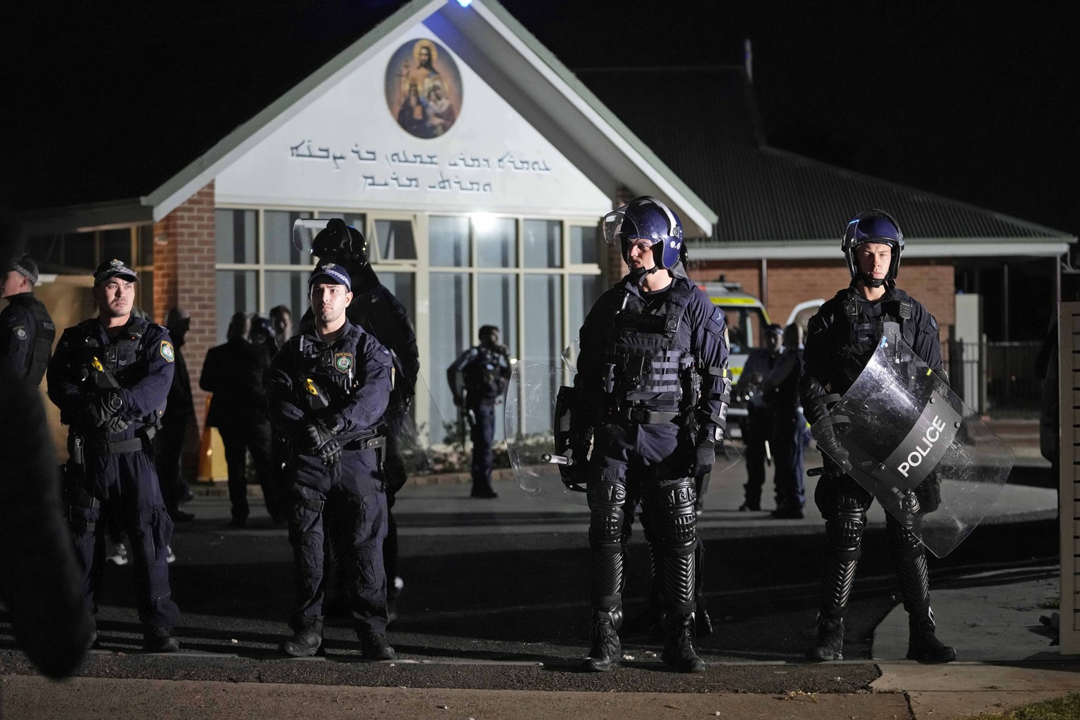 Security officers stand guard outside Orthodox Assyrian church in Sydney, Australia, Monday, April 15, 2024. Police in Australia say a man has been arrested after a bishop and churchgoers were stabbed ...