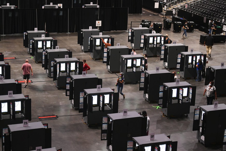 epa08739287 State Farm Arena is used as a polling place on the first day of early voting in the US Presidential election, shown underway in Atlanta, Georgia, USA, 12 October 2020. EPA/JOHN AMIS