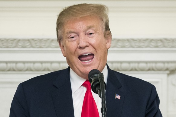 epa07413913 US President Donald J. Trump delivers remarks at an event for the National Association of Attorneys General, in the State Dining Room of the White House in Washington, DC, USA, 04 March 20 ...