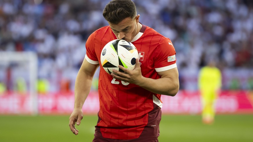 Switzerland&#039;s Xherdan Shaqiri kisses the ball before taking a corner kick during the quarter final match between England and Switzerland at the Euro 2024 soccer tournament in Duesseldorf, Germany ...