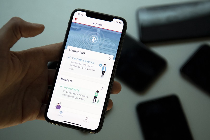 epa08381375 A smart phone app using Decentralized Privacy-Preserving Proximity Tracing (DP-3T) is pictured before a test with Swiss soldiers at the Swiss Federal Institute of Technology (EPFL) during  ...