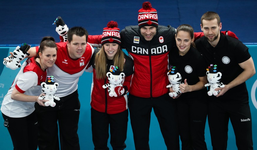 epa06521318 Gold medal winner John Morris (R) and teammate Kaitlyn Lawes (L) of Canada celebrate on the podium for the Mixed Doubles final with silver medalist Roman Rios (2L) and Jenny Perret(L) of S ...