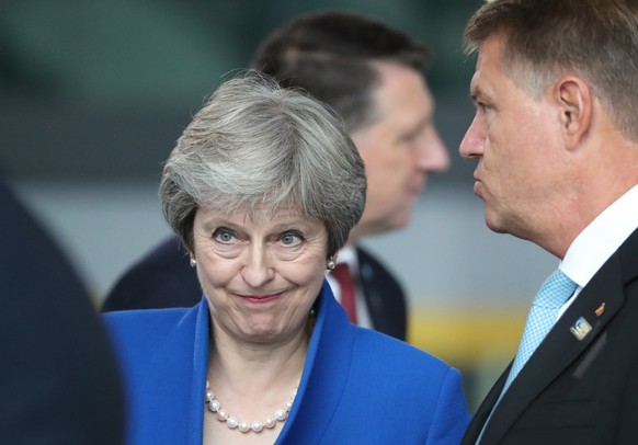 epa06880629 Romanian President Klaus Iohannis (R) and British Prime Minister Theresa May (C) at NATO headquarters in Brussels, Belgium, 11 July 2018. NATO countries&#039; heads of states and governmen ...