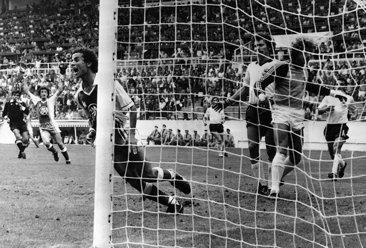 Algeria's Lakhdar Belloumi, left, turns and celebrates after scoring the second goal for his team during the Football World Cup match between Algeria and West Germany in Gijon, Spain on June 16,  ...