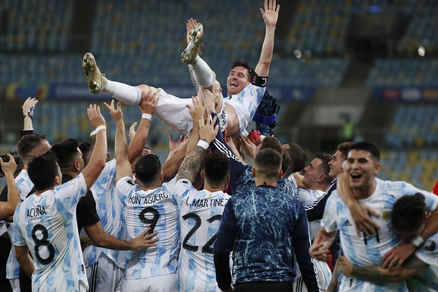 Teammates lift Argentina&#039;s Lionel Messi after beating Brazil 1-0 during the Copa America final soccer match at the Maracana stadium in Rio de Janeiro, Brazil, Saturday, July 10, 2021. (AP Photo/B ...