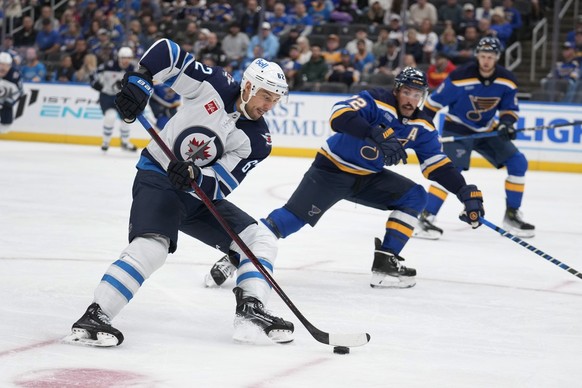 Winnipeg Jets&#039; Nino Niederreiter (62) handles the puck as St. Louis Blues&#039; Justin Faulk (72) defends during the first period of an NHL hockey game Tuesday, Oct. 22, 2024, in St. Louis. (AP P ...