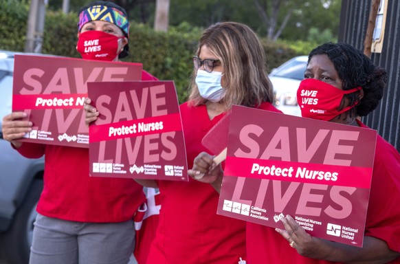 epa08585176 Registered nurses attend to a rally demanding optimal personal protective equipment and safe staffing at the Miami VA Healthcare System in Miami, Florida, USA, 05 August 2020. Thousands of ...