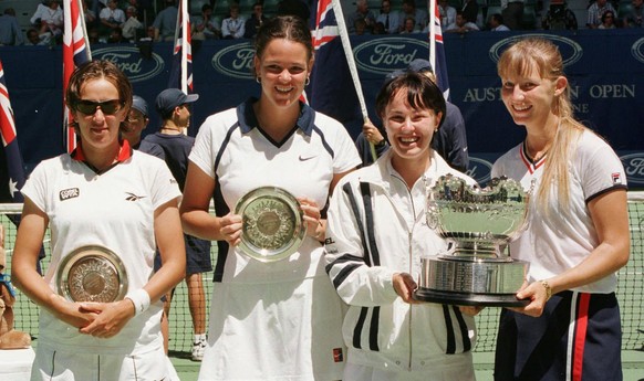 Martina Hingis of Switzerland, second from right, and Mirjana Lucic of Croatia, right, hold their trophies after their 6-4, 2-6, 6-3, victory over Lindsay Davenport of the United States, second from l ...