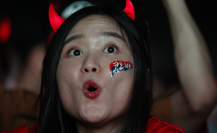 epa06833926 South Korean soccer supporters cheer in front of the Seoul city hall in Seoul, South Korea. 24 June 2018, watching the group F preliminary round match South Korea vs Mexico at the FIFA Wor ...