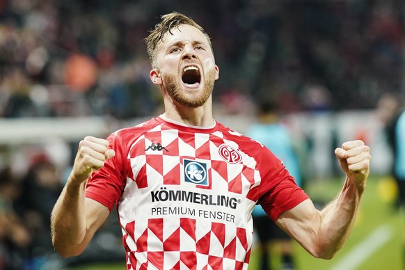 Mainz's Silvan Widmer of Mainz celebrates his goal to make it 1:1, during the Bundesliga soccer match between Mainz and Borussia Moenchengladbach at Mewa Arena in Mainz, Germany, Friday, Nov. 5, 2021. ...