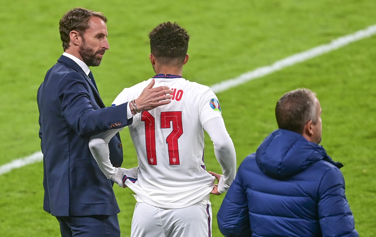 England's manager Gareth Southgate talks with England's Jadon Sancho as he takes the field during the Euro 2020 soccer championship group D match between the Czech Republic and England at We ...