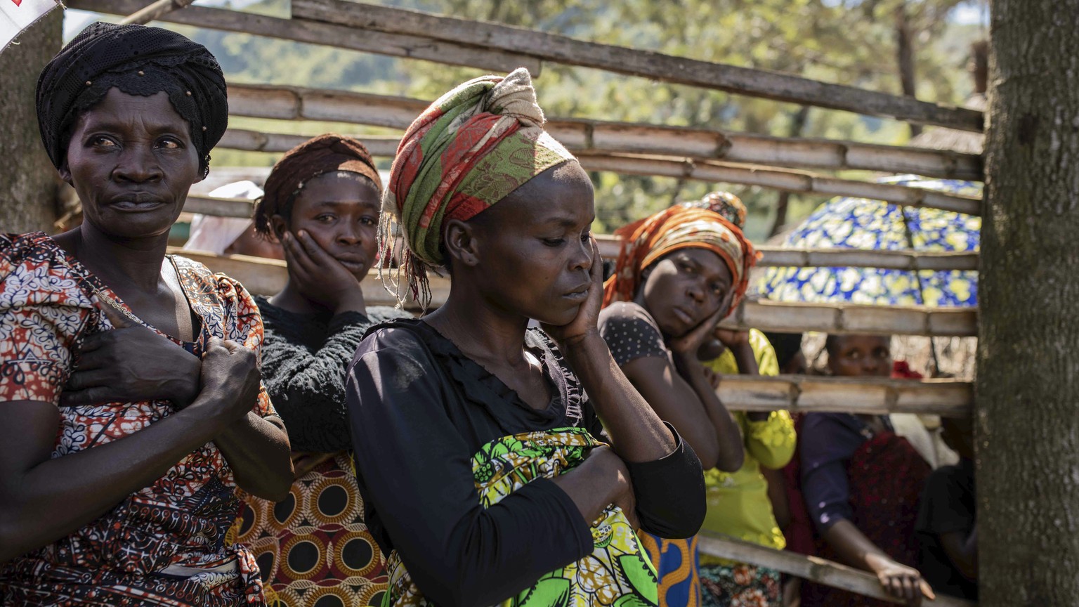Women react as villagers gather to identify bodies in the village of Nyamukubi, South Kivu province, in Congo Saturday, May 6, 2023. The death toll from flash floods and landslides in eastern Congo ha ...