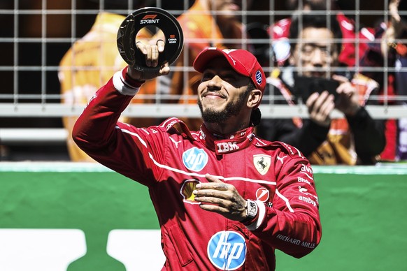 epa11980320 Scuderia Ferrari driver Lewis Hamilton of Britain celebrates after winning the Sprint race prior to the Formula One Chinese Grand Prix, at the Shanghai International Circuit in Shanghai, C ...
