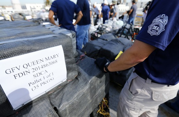 Drug Enforcement Agency (DEA) agents take inventory of seized cocaine packages, on the deck of the U.S. Coast Guard Cutter Boutwell at Naval Base San Diego in San Diego, October 6, 2014. Some 28,000 p ...