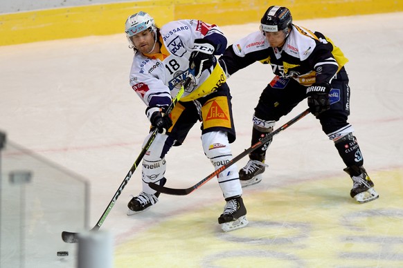 Ambri&#039;s player Ambri&#039;s player Joel Neuenschwander, right, fights for the puck with Zug&#039;s player Dominik Schlumpf, left, during the preliminary round game of National League Swiss Champi ...