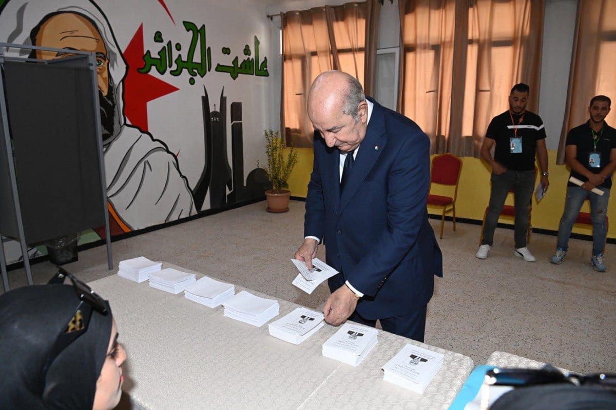 epa11591256 A handout picture provided by the Algerian Presidency Press Service shows Algerian President, Abdelmadjid Tebboune (L), prepares to cast his ballot at a polling station during the Presiden ...