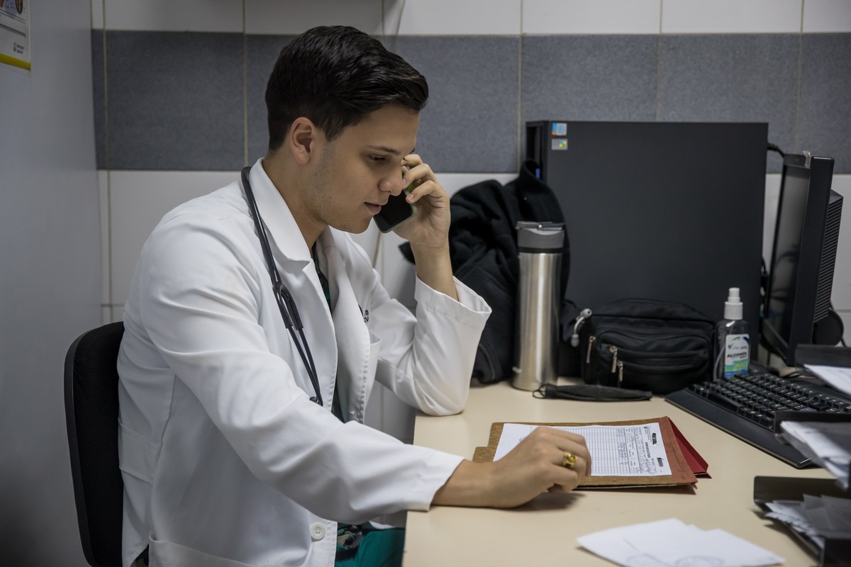 epa10030080 Dr. Francisco Machado speaks on the phone in his office in Caracas, Venezuela, 20 June 2022 (issued 23 June 2022). 'I'm a doctor and I'm also a drag queen.' This is how ...