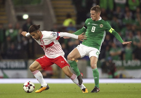 Northern Ireland&#039;s Steven Davis, right, and Switzerland&#039;s Ricardo Rodriguez battle for the ball during the World Cup qualifying play-off first leg soccer match between Northern Ireland and S ...