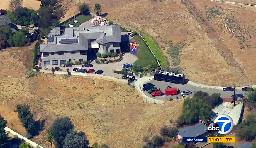 This image from aerial video provided by KABC-TV shows the home of entertainer Chris Brown with a police vehicle outside, in the Tarzana area of Los Angeles Tuesday, Aug. 30, 32016. Authorities waited ...