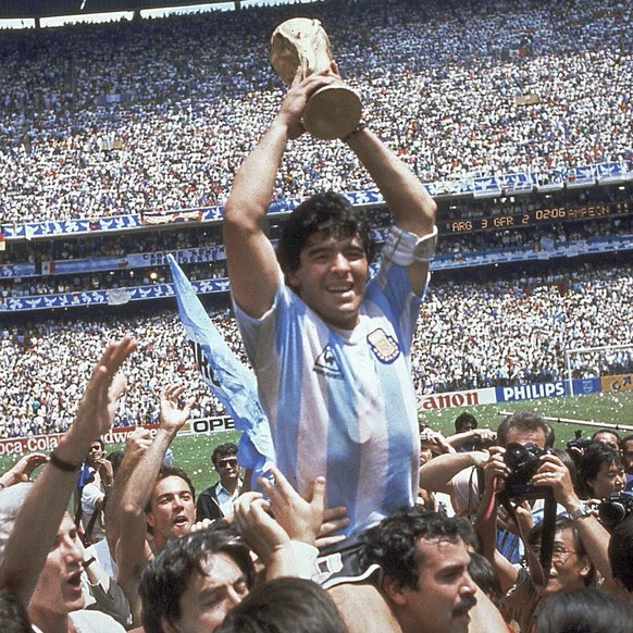 FILE - In this June 29, 1986 file photo, Diego Maradona holds up his team&#039;s trophy after Argentina&#039;s 3-2 victory over West Germany at the World Cup final soccer match at Atzeca Stadium in Me ...