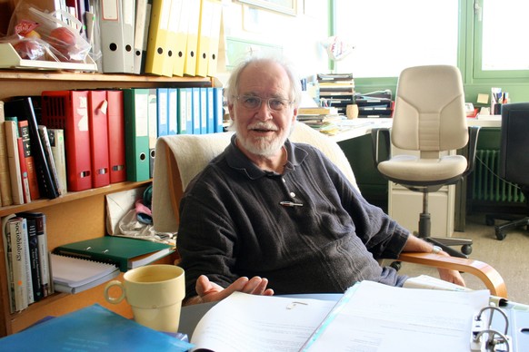 In this picture released by the University of Lausanne, Switzerland, Jacques Dubochet, chemistry professor at the University of Lausanne (UNIL), poses in his office, in Lausanne, Switzerland, in 2006. ...