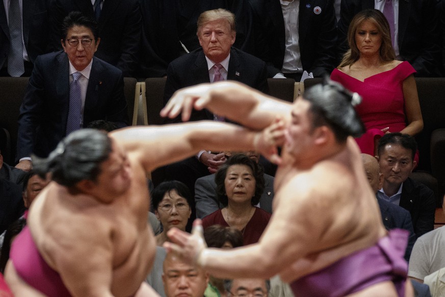 President Donald Trump attends the Tokyo Grand Sumo Tournament with Japanese Prime Minister Shinzo Abe at Ryogoku Kokugikan Stadium, Sunday, May 26, 2019, in Tokyo. First lady Melania Trump is at top  ...