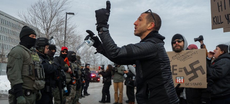 epa12643877 Protesters face off with federal officers and police outside of the Whipple Federal Building in Minneapolis, Minnesota, USA, 11 January 2026. As part of a federal immigration crackdown inv ...