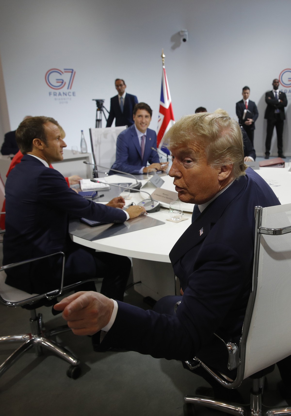 French President Emmanuel Macron, left and, U.S. President Donald Trump attend a G7 working session on "International Economy and Trade, and International Security Agenda" during the G7 summ ...