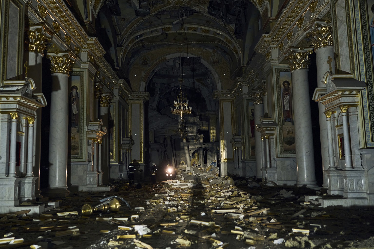 Firefighters walk inside the Odesa Transfiguration Cathedral, heavily damaged in a Russian missile attack in Odesa, Ukraine, Sunday, July 23, 2023. (AP Photo/Libkos)
