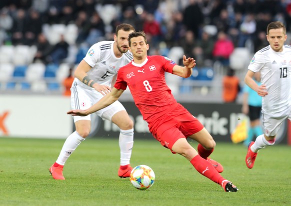 epa07458451 Switzerland&#039;s Remo Freuler (R) in action against Georgia&#039;s Nika Kvekveskiri (L) during the UEFA EURO 2020 Group D qualifier soccer match at the Boris Paichadze national stadium i ...