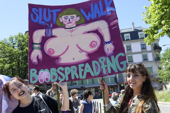 epa06033707 Women hold up signs and shout slogans during the swiss Slutwalk demonstration in Geneva, Switzerland, 17 June 2017. The protest march is calling for an end to rape culture, including victi ...