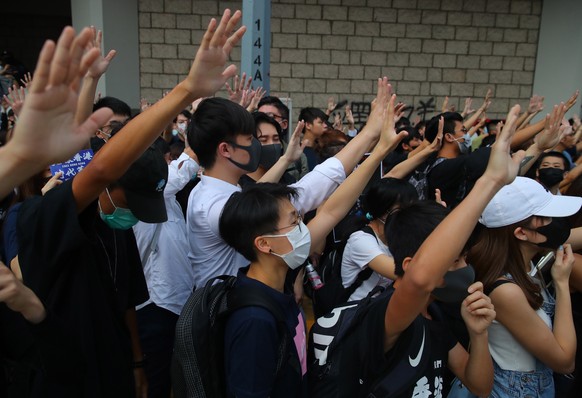 epa07906513 Protesters supporting activist Edward Leung gestures as they gather outside the High Court during an appeal hearing for his period of sentence, in Hong Kong, China, 09 October 2019. Hong K ...