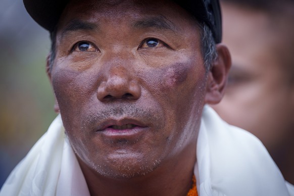 FILE- Veteran Sherpa guide Kami Rita returning after scaling Mount Everest for the 28th time arrives at the airport in Kathmandu, Nepal, May 25, 2023. The race for the most successful ascents of Mount ...