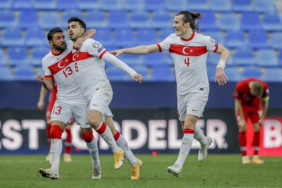 Turkey's Ozan Tufan, second left, celebrates with his teammates after scoring his side's third goal during a World Cup 2022 group G qualifying soccer match between Norway and Turkey at La Ro ...