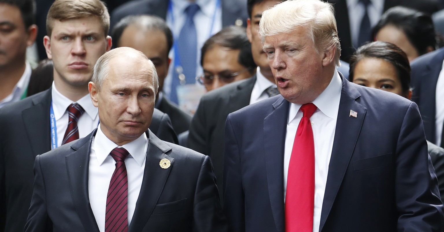 FILE - This Saturday, Nov. 11, 2017 file photo, shows U.S. President Donald Trump and Russia&#039;s President Vladimir Putin talking during the family photo session at the APEC Summit in Danang, Vietn ...