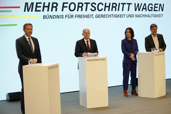 Social Democratic Party, SPD, chancellor candidate Olaf Scholz, second left, stands with the Green party leaders Annalena Baerbock, third from left, Robert Habeck, right, and the Free Democratic Party ...