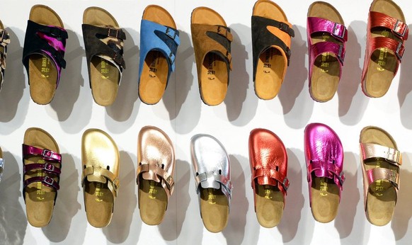 epa04021198 A employee arranges shoes of German label Birkenstock during the fashion fair &#039;Bread &amp; Butter&#039; in the former Tempelhof airport in Berlin, Germany, 14 January 2014. &#039;B&am ...
