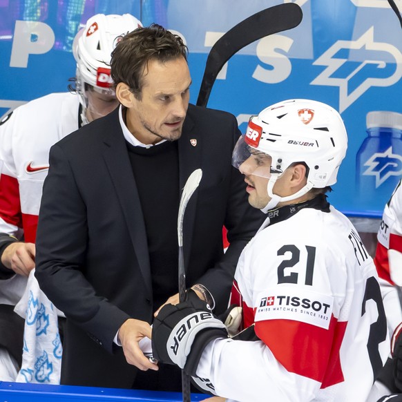 Patrick Fischer, head coach of Switzerland national ice hockey team, talks to Switzerland&#039;s forward Kevin Fiala #21, during the IIHF 2025 World Championship preliminary round group B game between ...