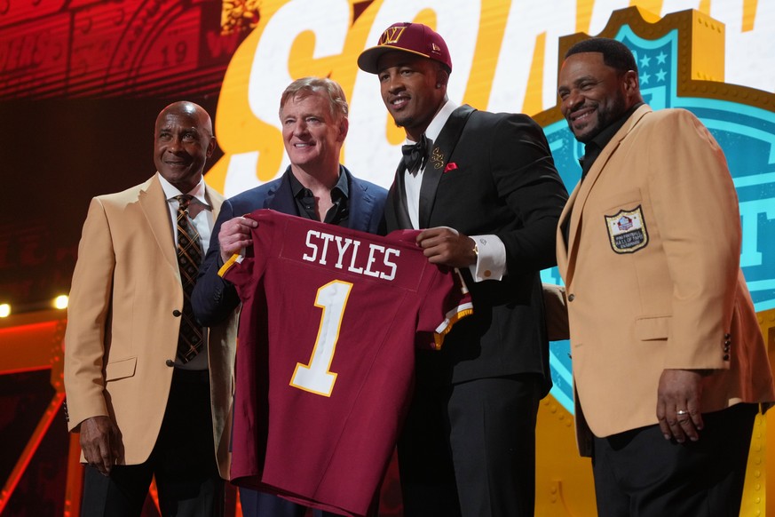 Ohio State linebacker Sonny Styles, center right, poses with NFL Commissioner Roger Goodell after being chosen by the Washington Commanders with the seventh overall pick during the first round of the  ...