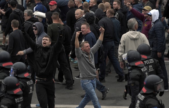 Men shout during a far-right protest in Chemnitz, Germany, Monday, Aug. 27, 2018 after a man has died and two others were injured in an altercation between several people of &quot;various nationalitie ...