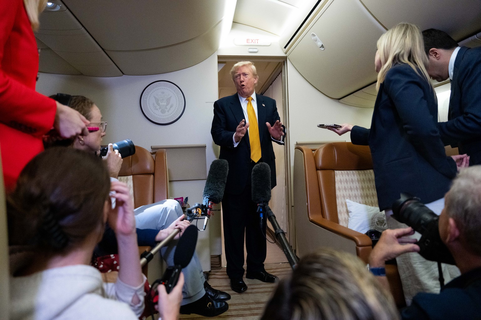 President Donald Trump speaks with reporters in flight on Air Force One after landing at U.S. Air Force Base at RAF Mildenhall, in Suffolk, Eastern England, Wednesday, July 8, 2026. (AP Photo/Alex Bra ...