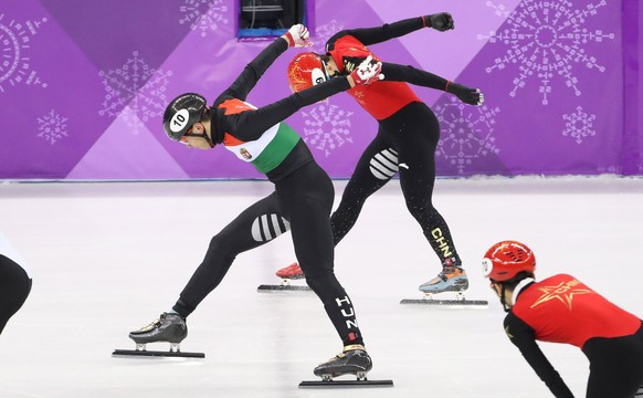 epa06553666 Liu Shaolin Sandor of Hungary crosses the finish line first to take gold for Team Hungary ahead of Han Tianyu of China in the Men's 5000 m Relay short track speed skating competition at the Gangneung Ice Arena during the PyeongChang 2018 Olympic Games, South Korea, 22 February 2018.  EPA/TATYANA ZENKOVICH