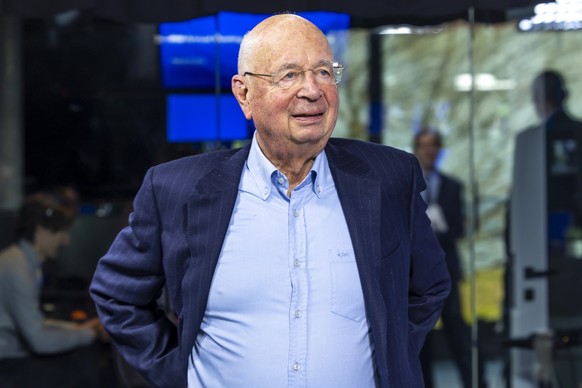 German Klaus Schwab, Founder and chairman of the Board of Trustees of the WEF, talks with the staff after a remote Pre-meeting press conference of the World Forum Annual Meeting 2025, in Cologny near  ...